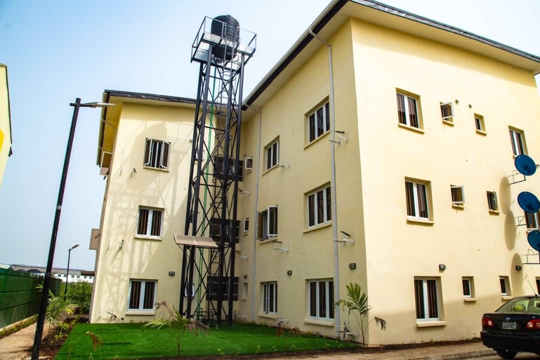 Side view of the flats with elevated water tank and landscaped lawn